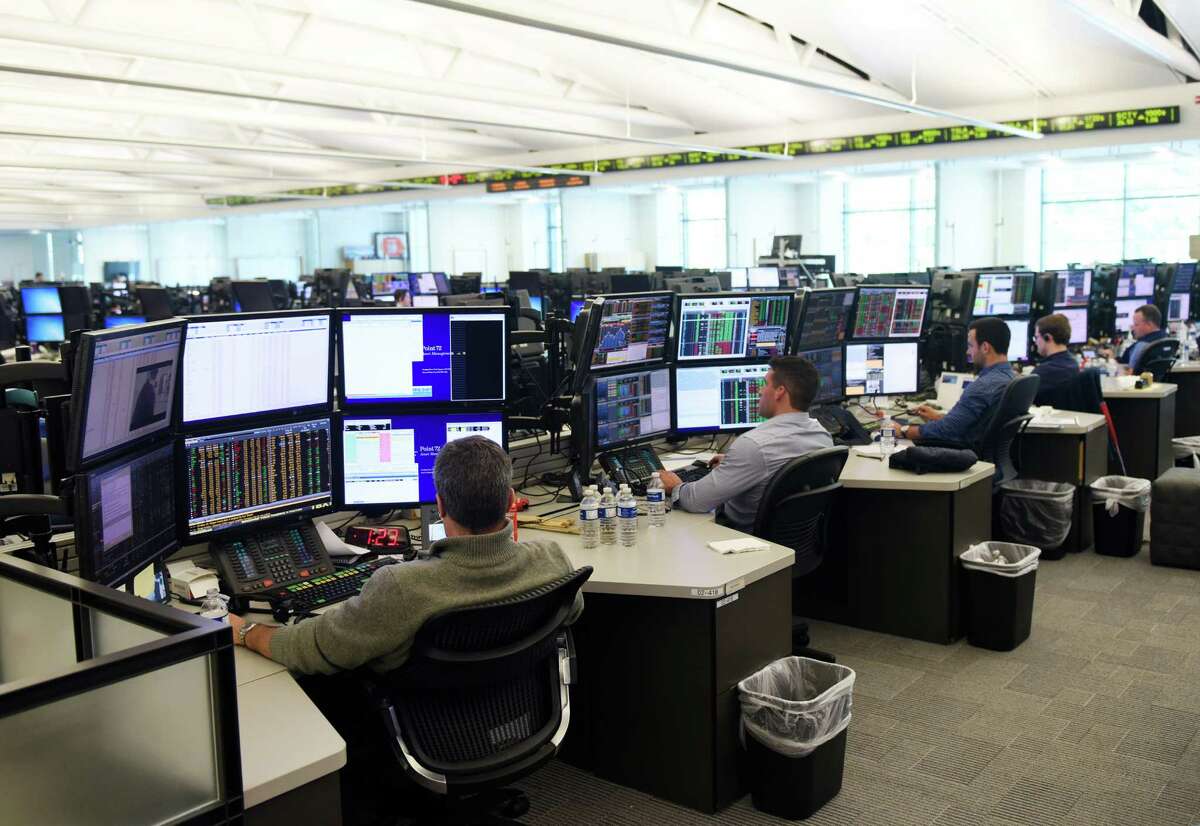 Investment professionals work on the trading floor at Point72 Asset Management's global headquarters in Stamford, Conn. Monday, July 18, 2016. Point72 is an investment company responsible for managing the assets of founder Steven Cohen and eligible employees, with its main office in Stamford and satellite offices in New York, London, Hong Kong, Tokyo and Singapore. Point72 currently has about $11 billion assets under management.