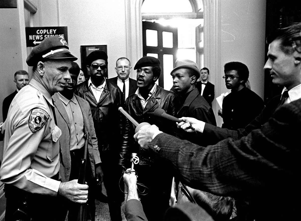 Members of the Black Panther Party argue with a California state policeman at the Capitol in Sacramento after he disarmed them May 2, 1967. The armed Panthers entered the Capitol protesting a bill before the Legislature that would restrict carrying arms in public. Men in berets at center are Panther leaders Eldridge Cleaver, left in sunglasses, and Bobby Seale. The policeman holds a weapon taken from the Panthers. (AP Photo)