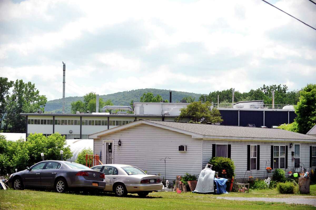 The Saint-Gobain Performance Plastics plant is seen behind homes along Carey Ave. on Tuesday, June 28, 2016, in Hoosick Falls, N.Y. (Paul Buckowski / Times Union)