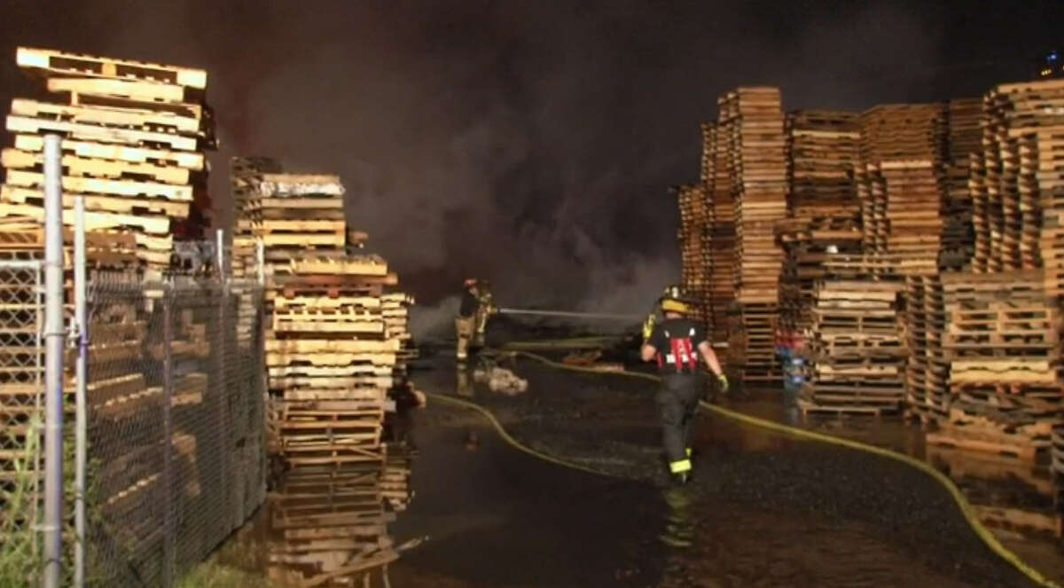 Almost 10 hours and at least 75,000 gallons of water later, a massive fire early Saturday July 23, in a northeast Harris County pallet yard is under control but still active.