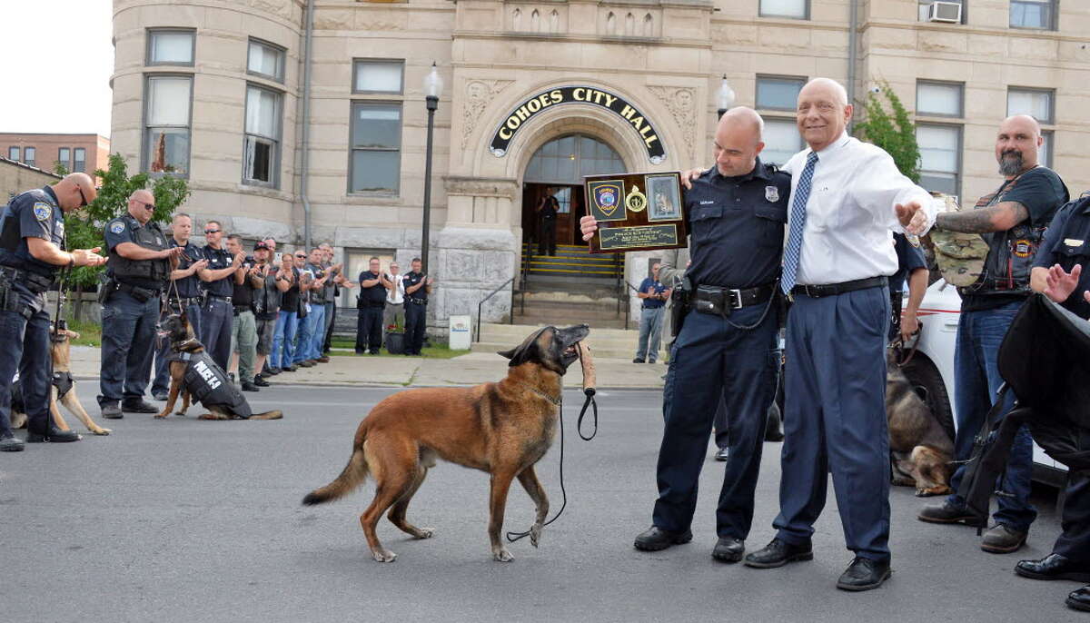 Officer and K-9 handler Sean McKown, center, and retiring K-9 Jeter receive a plaque from Cohoes Mayor George Primeau outside Cohoes Police Station Wednesday Sept. 9, 2015 in Cohoes, NY. (John Carl D'Annibale / Times Union)