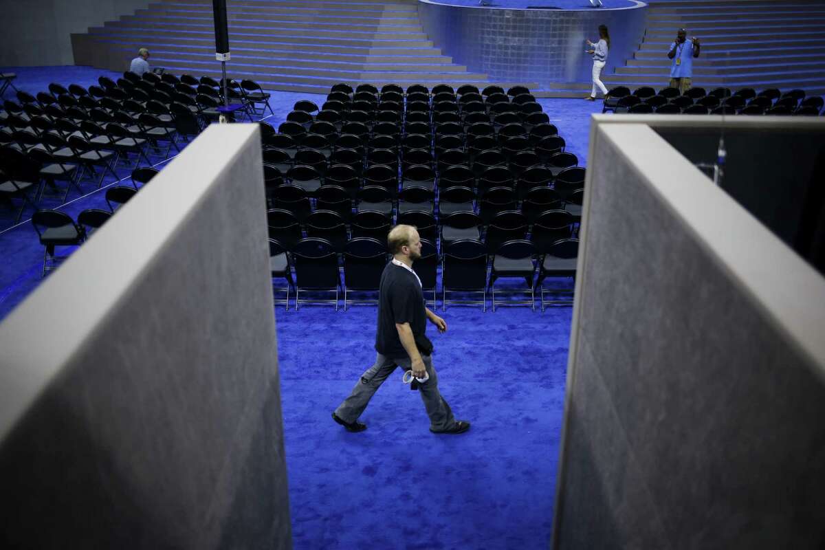 A worker walks the floor inside the Wells Fargo Center ahead of the Democratic National Convention (DNC) in Philadelphia, Pennsylvania, U.S., on Saturday, July 23, 2016. Hillary Clinton named Virginia Senator Tim Kaine as her running mate for the Democratic presidential ticket, a widely-anticipated choice that may say more about how she wants to govern than how she plans to win in November. Photographer: John Taggart/Bloomberg