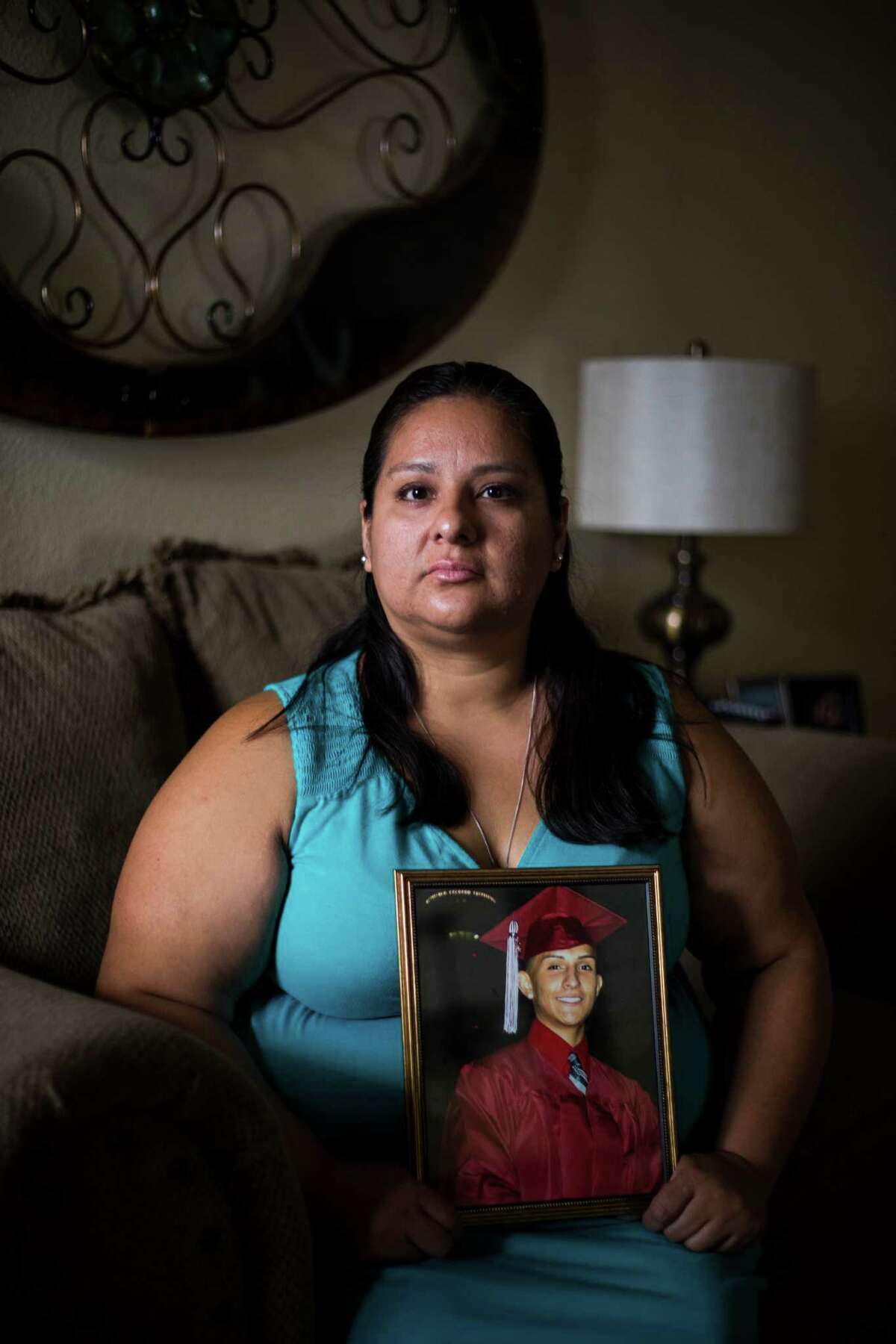 Debra De La Garza holds her son's graduation image at her home in San Antonio, on Tuesday, July 19, 2016. Garza lost her 19-year-old son, Manuel Carvajal, to a drug overdose last year and is now planning a memorial service, set for late August, in addition to being active in overdose recognition in San Antonio.