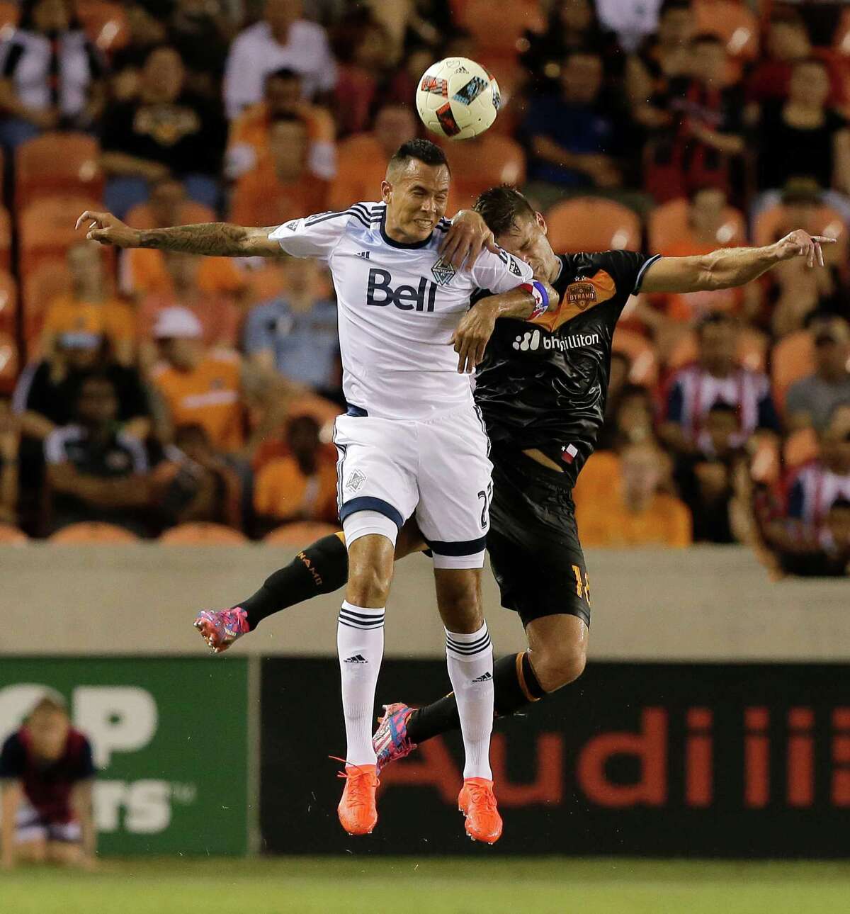 Vancouver Whitecaps forward Blas Perez (27) and Houston Dynamo defender David Horst (18) go up for a header during the second half during an MLS soccer match Saturday, July 23, 2016, in Houston. Houston and Vancouver played to scoreless draw. (AP Photo/Bob Levey)