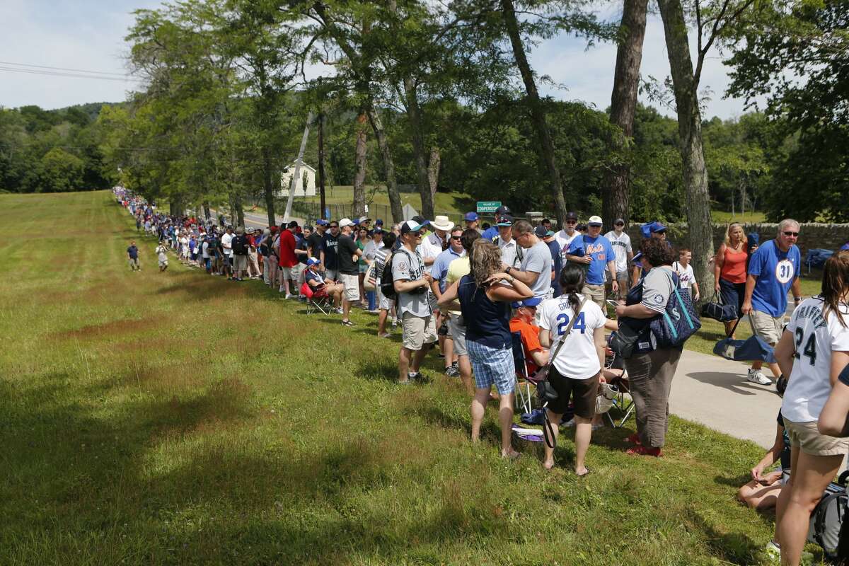 Fans line up along Susquehanna Avenue before the National Baseball Hall of Fame induction ceremony at the Clark Sports Center on Sunday, July 24, 2016, in Cooperstown, N.Y.