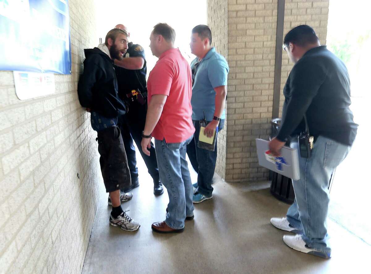 SAPD Mental Heath Unit officers talk with a homeless man. Law enforcement must know where to take a psychiatric emergency.