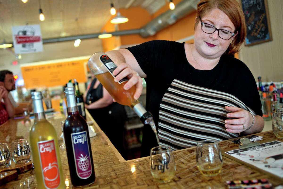 Modern Craft director of events Liberty Starkweather Smith makes drinks using Modern Craft wine at the Modern Craft tasting room inside Brewin' On McEwan in downtown Clare.