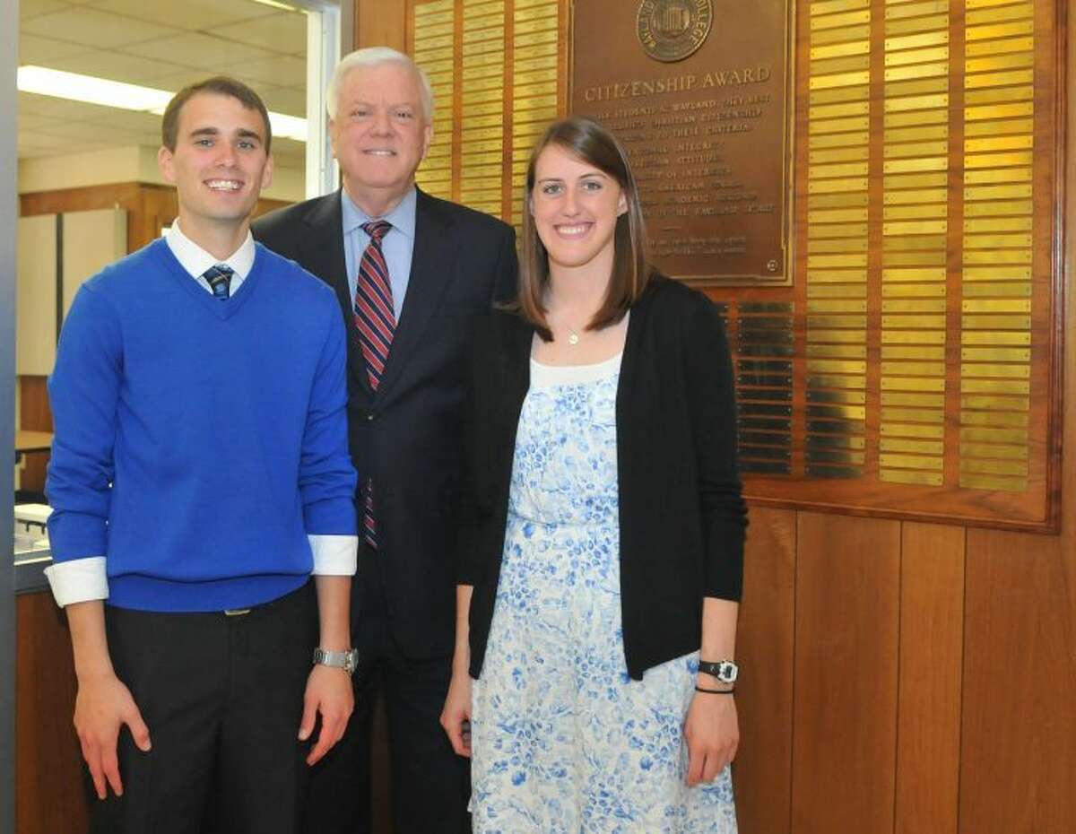 Wayland Baptist University seniors Kennan Harris of Perryton and Libby Saultz of Amarillo stand with Wayland President Dr. Paul Armes in front of the Citizenship Award plaque in Gates Hall. Harris and Saultz affixed their names to the plaque as the 57th man and woman to receive the Citizenship Award, the highest recognition given to Wayland students. The award was announced Wednesday during the annual Recognition Chapel.