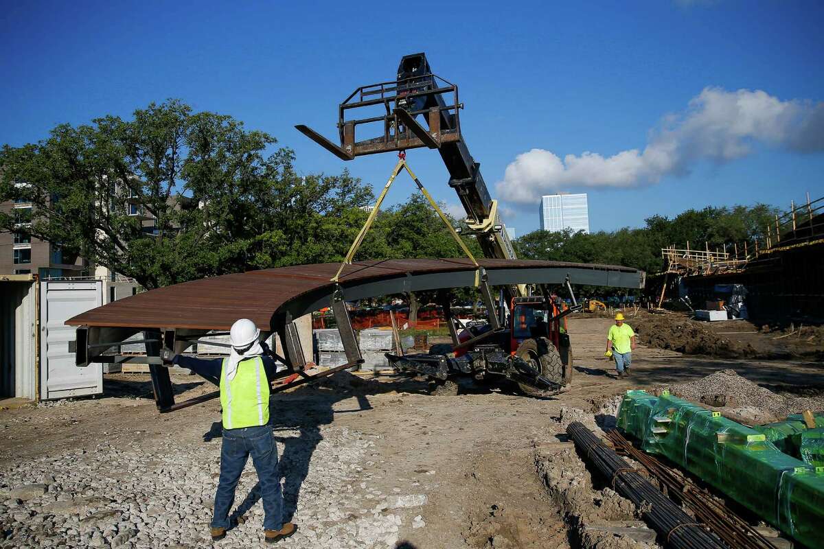 Construction crews work on placing boardwalks in Levy Park, a nearly six-acre piece of land in the Upper Kirby District, Friday, July 22, 2016. The public park is expected to be partially open by October. ( Michael Ciaglo / Houston Chronicle )