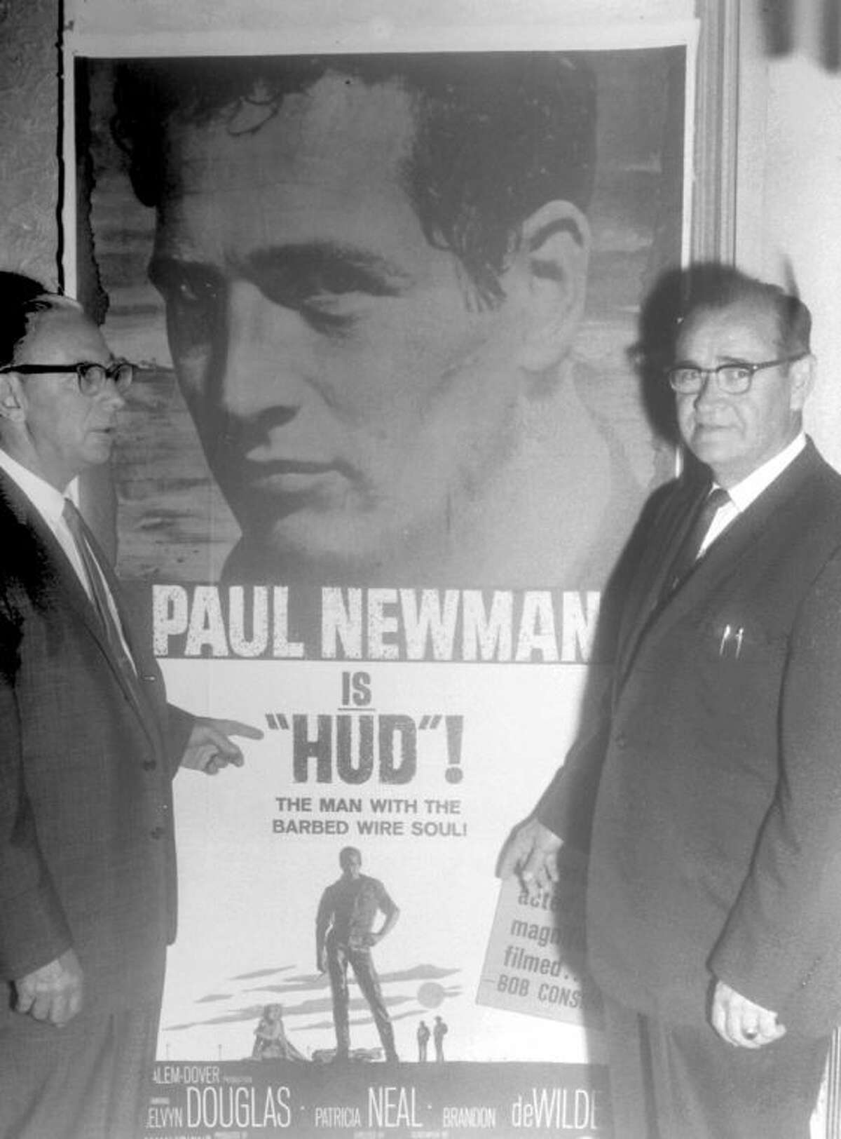 Herald File PhotoIn a photo published by the Herald on June 2, 1963, Price Holland (left) and C.E. McSwain, partners in the operation of Plain view’s five movie theaters, stand before a poster advertising “Hud,” starring Paul Newman. The movie was being shown at the Granada. Other local theaters were the Fair, Texas (Spanish), Twin-Vue Drive-In and Sunset Drive-In.