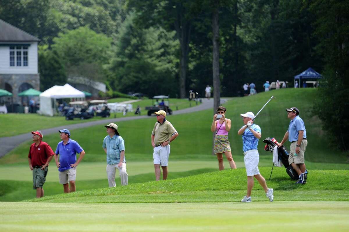 John Dailey, of H. Smith Richardson Golf Course in Fairfield, Conn., hits a shot off the fairway in front of a crowd during day 1 of the Connecticut Open at the Woodway Country Club in Darien, Conn. on Monday, July 25, 2016.