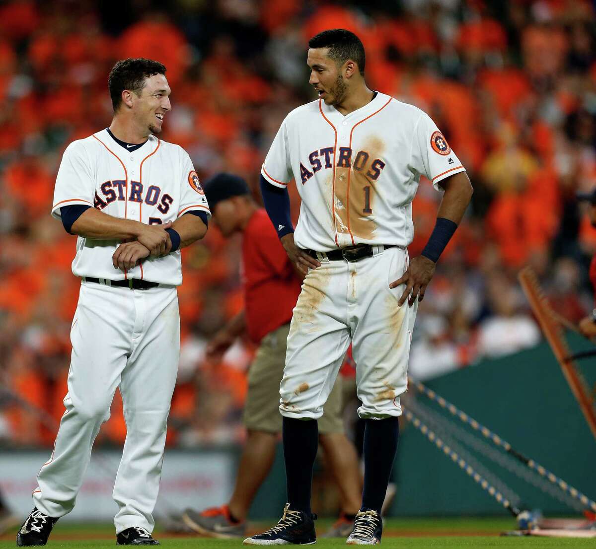 Houston Astros third baseman Alex Bregman (2) chats with shortstop Carlos Correa (1) after his flyout ending the sixth inning of an MLB game at Minute Maid Park, Monday, July 25, 2016, in Houston.