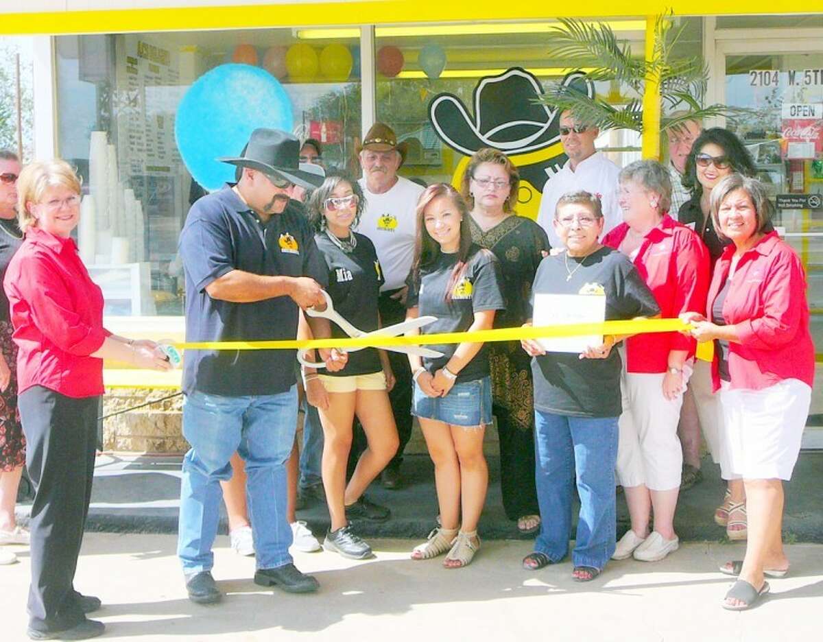 Jorge Montelongo, owner of AC's Delights at 2104 W. Fifth, cuts the ribbon at a Plainview Chamber of Commerce ceremony Friday. The business features homemade ice cream cups, aguas drescas, shaved ice, ice made with reverse osmosis water and fresh fruit as well as chips and nachos. Misters keep customers cool, and activities include volleyball, horseshoes, checkers, dominoes, chess and card games. Pictured with Montelongo are his staff, Mia Rosales, Iriz Davila, Alice Montelongo and Alicia Montelongo, along with Chamber representatives Doris McDonald (left), Matt Kelley (background), Janice Payne, Frances Barrera and Lydia Castillo.