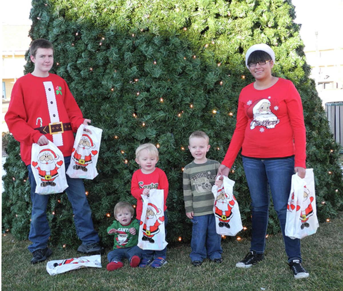 4-H members will help Santa distribute gift bags at Breakfast with Santa at the Ollie Liner Center. Jonathon Farmer is the helper at left, and Beatrice Rodriguez is the helper at right. Kleat Barrett (left), Colt Barrett and Alex Farmer are waiting for Santa.