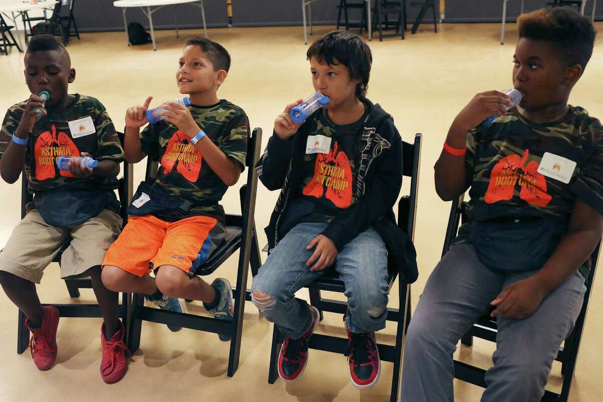 From left, Joe Anthony Holmes, 9, Armando Hernandez, 9, Gage Acevedo, 11, and Mikyl Vance, 10, try spacer devices during a free asthma boot camp hosted by the University of Texas Health Science Center San Antonio at the DoSeum, San Antonios Museum for Kids, Monday, July 25, 2016. The camp is for children ages 7-12 and will help them learn about asthma prevention and triggers, among other critical information. Officials say asthma is a leading cause of absenteeism from school. The spacer devices are to facilitate the use of metered-dose asthma inhalers.