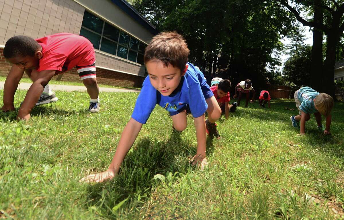 Adrian Adam and his classmates walk like inchworms to measure distance during the three-week summer school program SPARK at Brookside Elementary School in Norwalk earlier this month. The SPARK project is a statewide initiative, located in four districts including Norwalk, to encourage more marginalized and diverse populations in "gifted" or academically talented programs.
