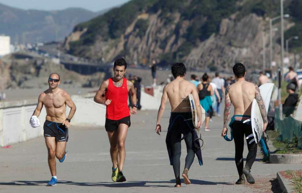 Runners and surfers enjoy the warm weather at Ocean Beach in San Francisco on Feb. 2, 2015. More sunny skies and toasty temperatures are in store the rest of this week for the Bay Area.