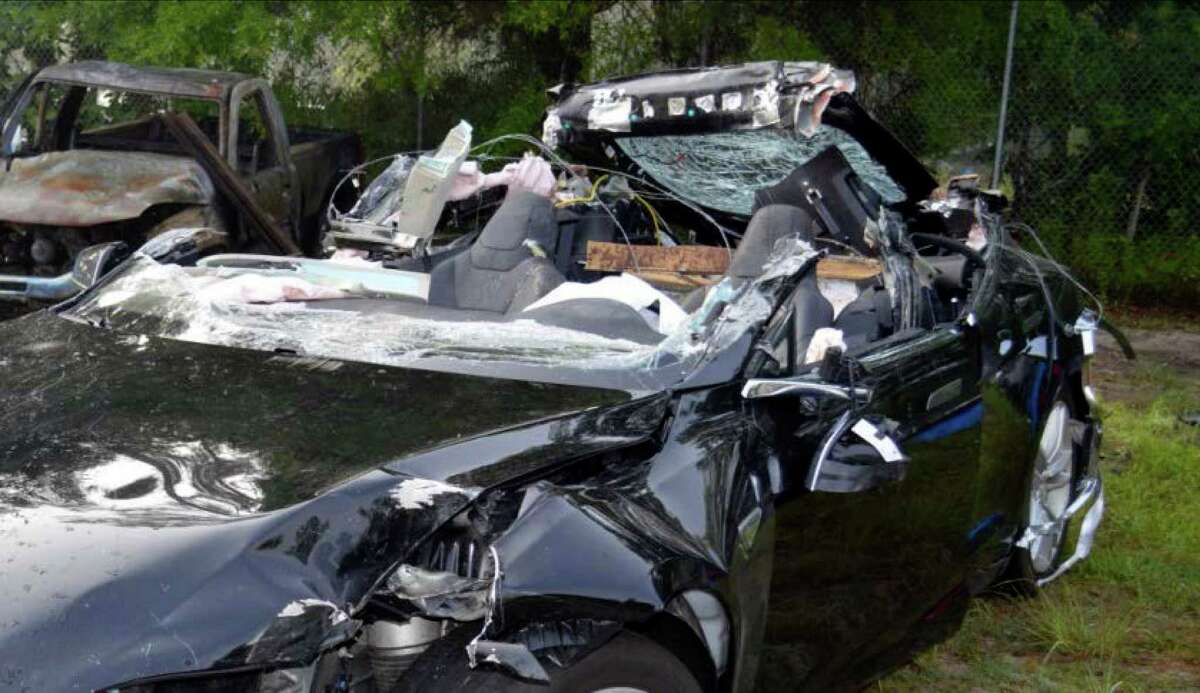 This photo provided by the NTSB via the Florida Highway Patrol shows the Tesla Model S that was being driven by Joshau Brown,who was killed, when the Tesla sedan crashed while in self-driving mode on May 7, 2016. The National Transportation Safety Board said in a preliminary report on July 26 that the Tesla Model S was traveling at 74 mph in a 65-mph zone on a divided highway in Williston, Fla., near Gainesville, just before hitting the side of a tractor-trailer. (NTSB via Florida Highway Patrol via AP)