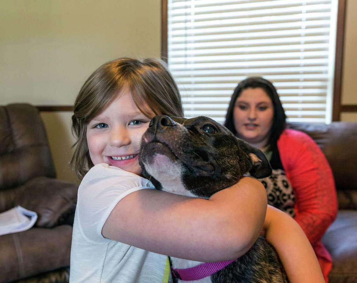 Maxie Foster, daughter Colbie and rescue dog Trix moved into a mobile home on her parents' property in Magnolia while she battles her former employer.