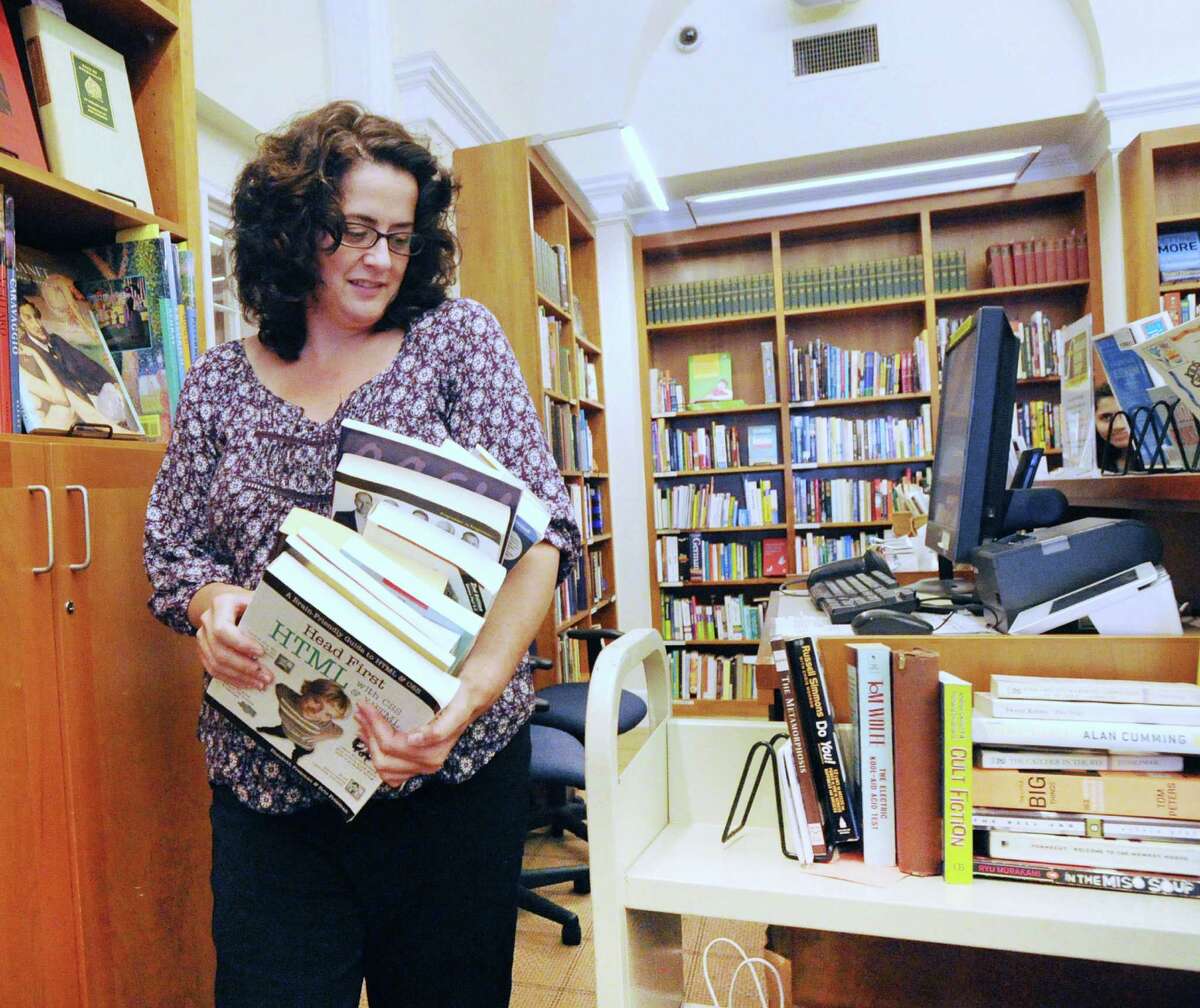 Katherine Spelling, a volunteer librarian stacks books during the second to last day of the Friends of the Ferguson Library book sale at the Ferguson Library on July 8.