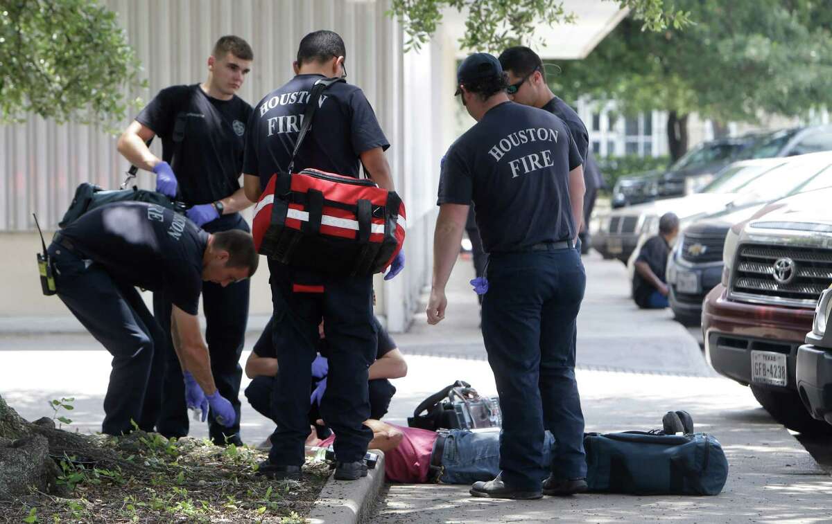 Houston Fire Department personnel respond to a call of a man down in a known drug area along Fannin and Wheeler near Peggy Park in Houston. ( Melissa Phillip / Houston Chronicle )