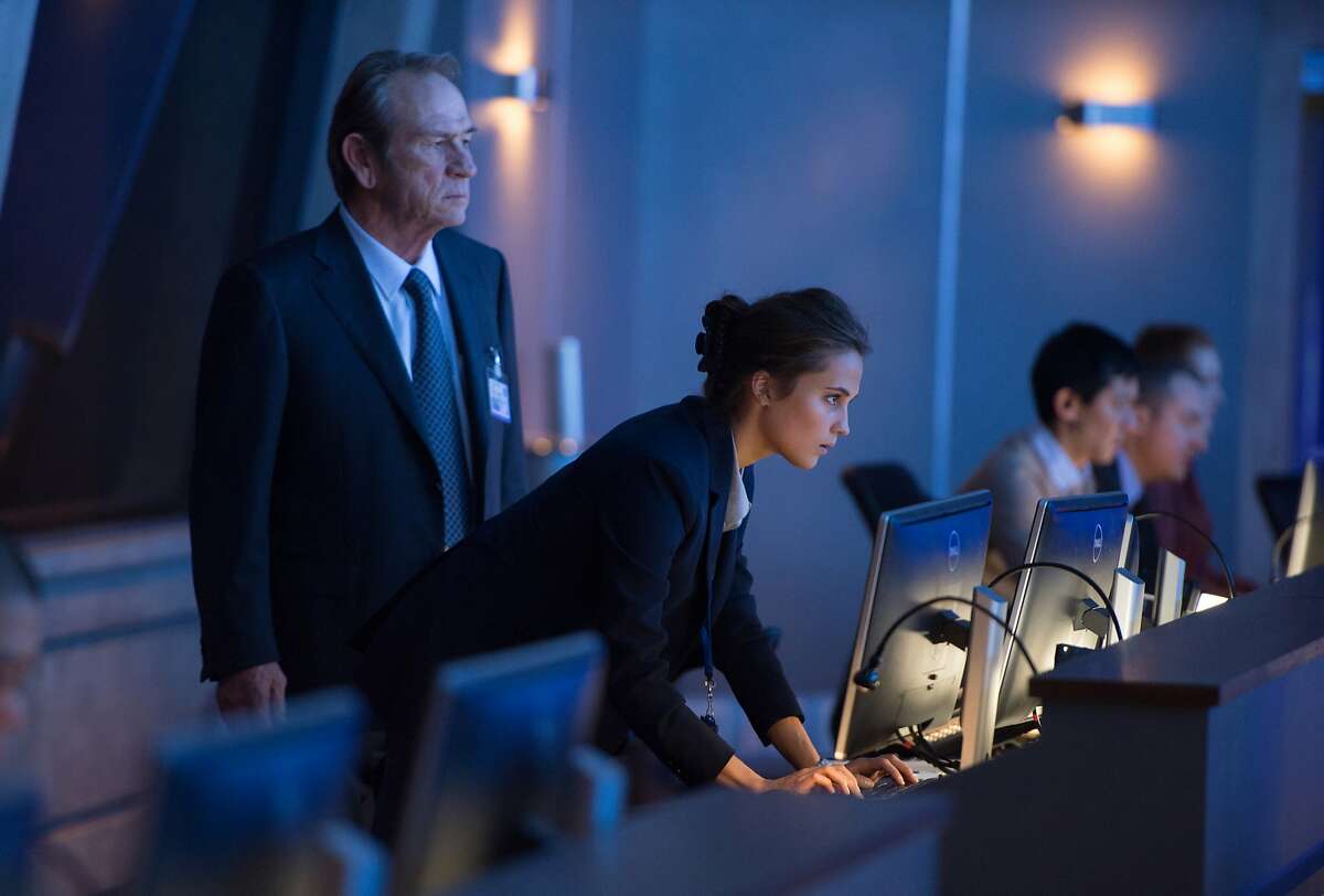 In this image released by Universal Pictures, Tommy Lee Jones, left, and Alicia Vikander appear in a scene from "Jason Bourne." (Jasin Boland/Universal Pictures via AP)