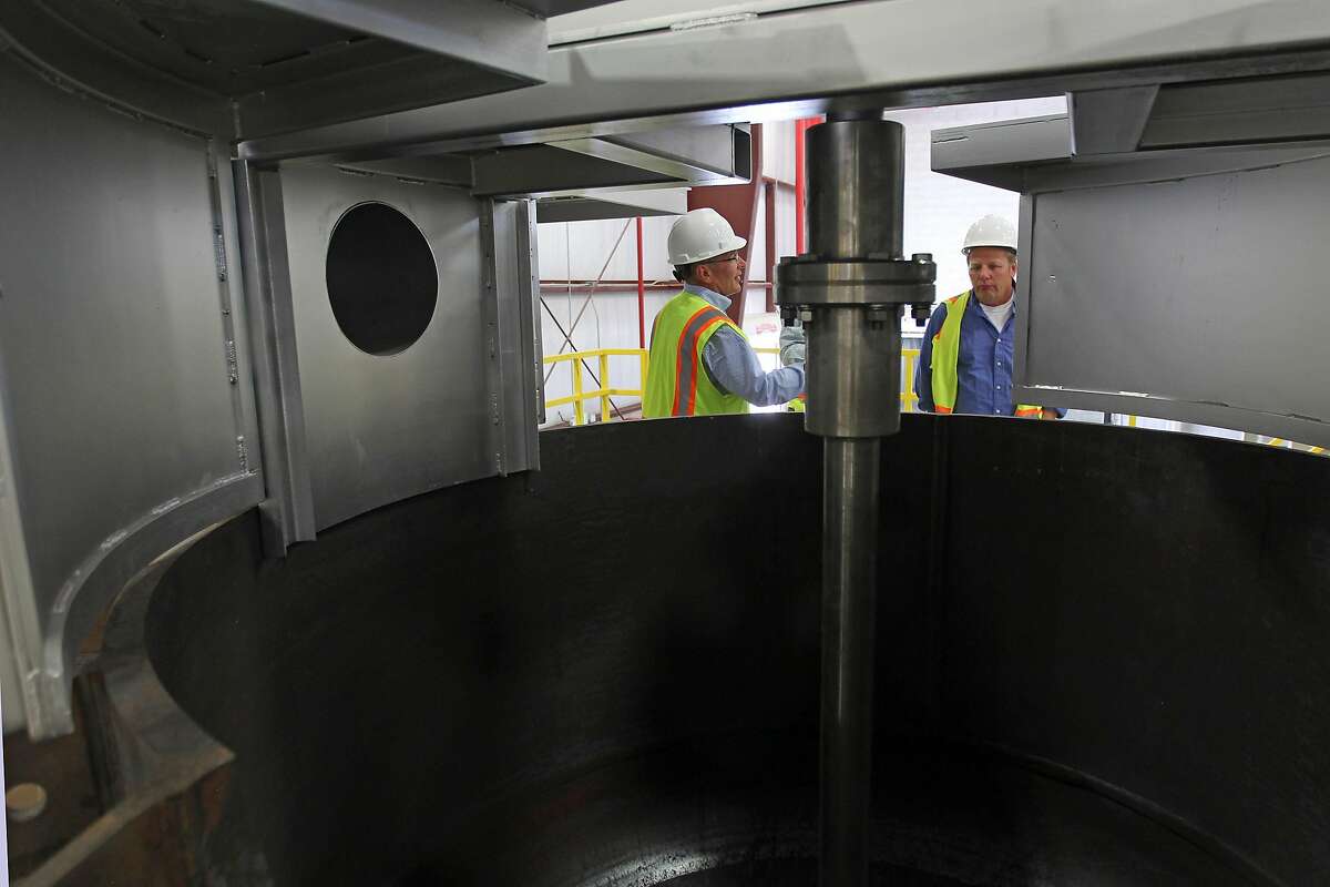 Selwyn Mould Chief Operating Officer and Michael Krickel Director of Recycling Technology stand over a large vat at Aqua Metals a new battery recycling plant outside Sparks Nev., Wednesday, July 27, 2016.