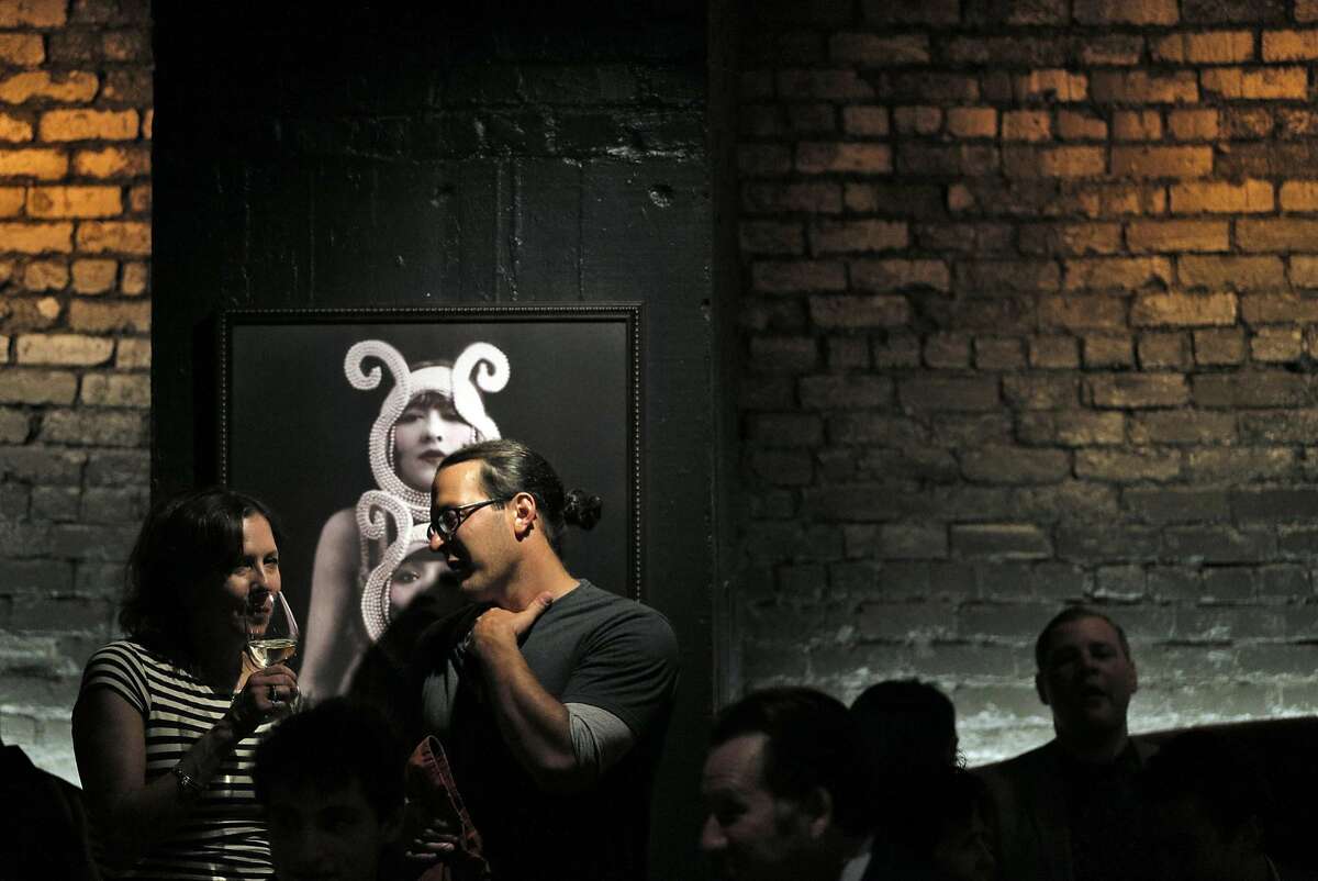 Guests enjoy drinks at the jazz performance in the downstairs bar area at the new Black Cat Restaurant and Bar in San Francisco, Calif., on Wednesday, July 27, 2016. Black Cat opens Thursday, July 28, and features a jazz revue in the lower floor.