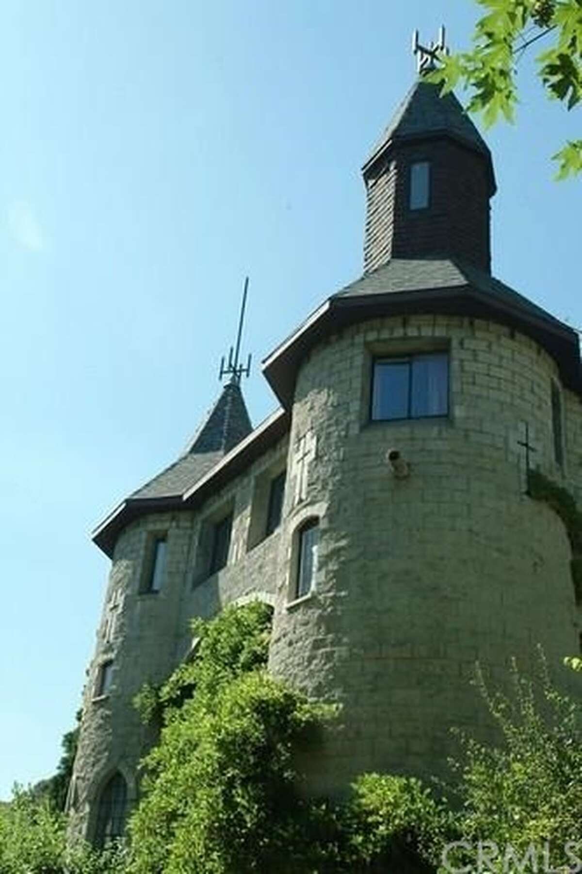 Castle with turrets and drawbridge on the market for 849,000 — in