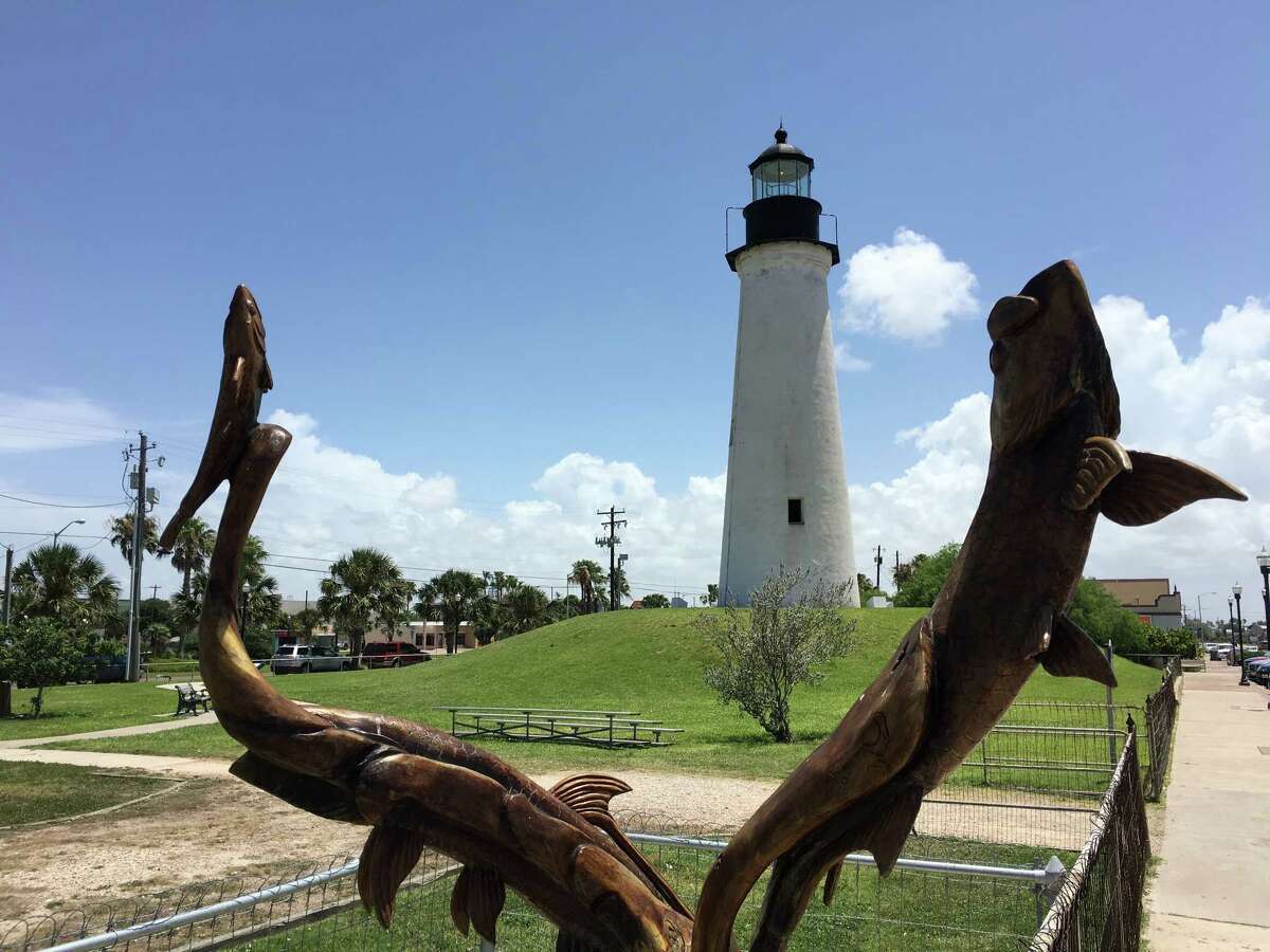 South Padre Island is an ideal location for a port of call, according a recent study. Pictured, a wood carving of fish with the Port Isabel lighthouse in the backdrop.