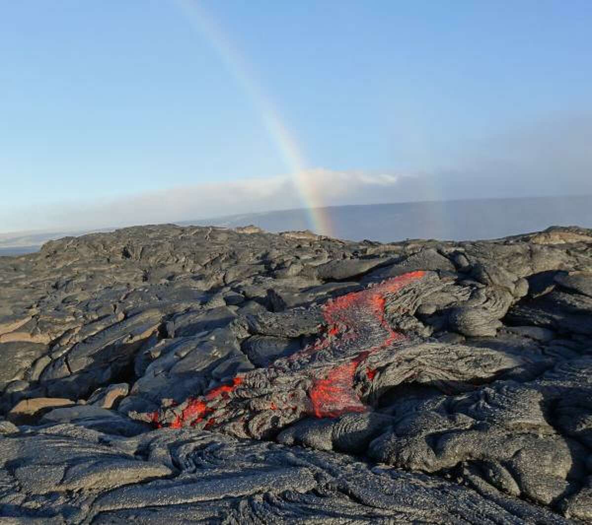 Molten lava from the Kilauea Volcano in Hawaii flows down a lava bed toward the sea in this July 2016 photo.