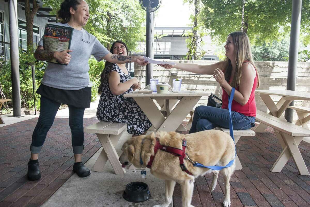 Year-round The Pearl: 303 Pearl Parkway, 210-212-7260, atpearl.com. Fine shops and fine dining go hand-in-paw at The Pearl, where well-behaved pets can join their bipedal pals at the eclectic establishments. The Pearl’s many pet-friendly restaurants include: La Gloria: 100 E. Grayson St., 210-267-9040, chefjohnnyhernandez.com/lagloria Boiler House Texas Grill & Wine Garden: 312 Pearl Parkway Bldg. 3, 210-354-4644, boilerhousesa.com Botika: 303 Pearl Parkway No. 111, 210-670-7684, botikapearl.com You also can indulge in Pearl retail therapy with your pet here: Adelante Boutique: 303 Pearl Parkway, No. 107, 210-826-6770, adelanteboutique.com The Tiny Finch (302 Pearl Parkway, No. 116, 210-253-9570, thetinyfinch.com) And don’t forget the Farmer’s Market at The Pearl on Saturdays and Sundays. Pictured are friends Erica Edmonds, second left, and Christina Campos, right, along with Archie the dog, placing their order with waitress Ericka Rodulfo, left, on the outside patio at Green Vegetarian Cuisine located at The Pearl in San Antonio.