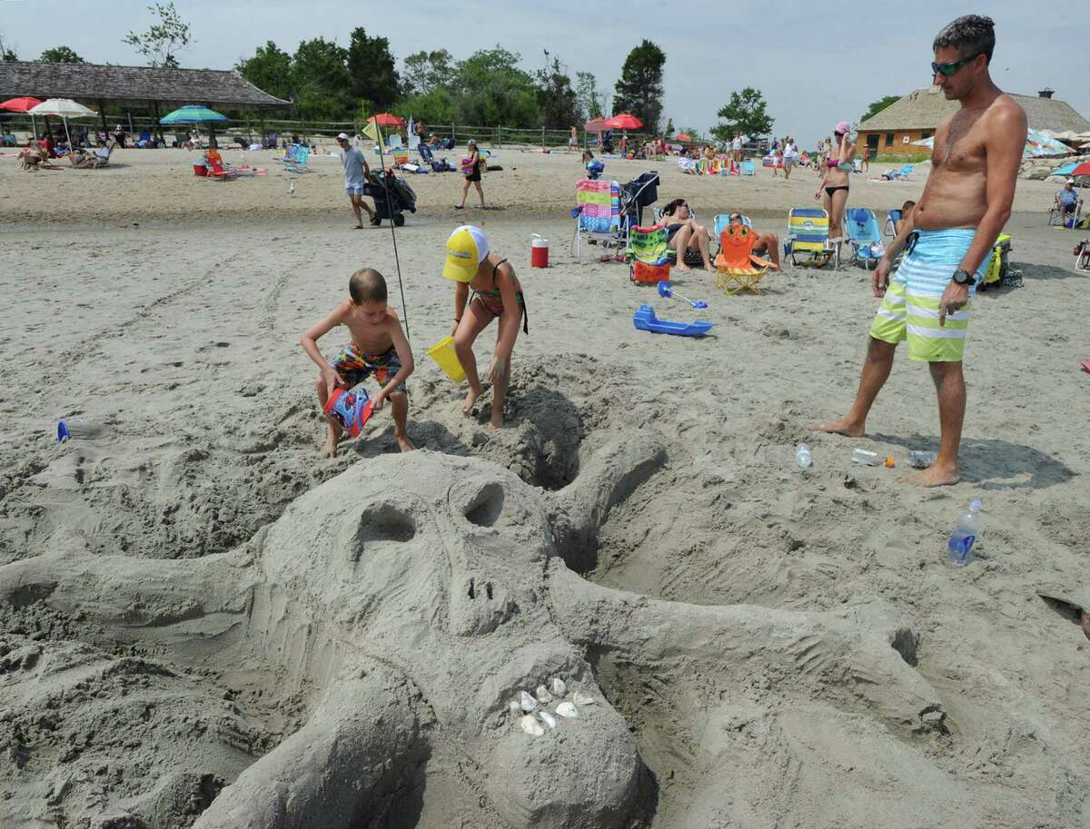 Steven Callaghan of Greenwich, right, help to supervise the construction of a skull and cross-bones sand sculpture during the annual Sandblast! sand sculpture competition sponsored by the Greenwich Arts Council and the Town of Greenwich Department of Parks and Recreation at Greenwich Point, Conn., Saturday, July 30, 2016.