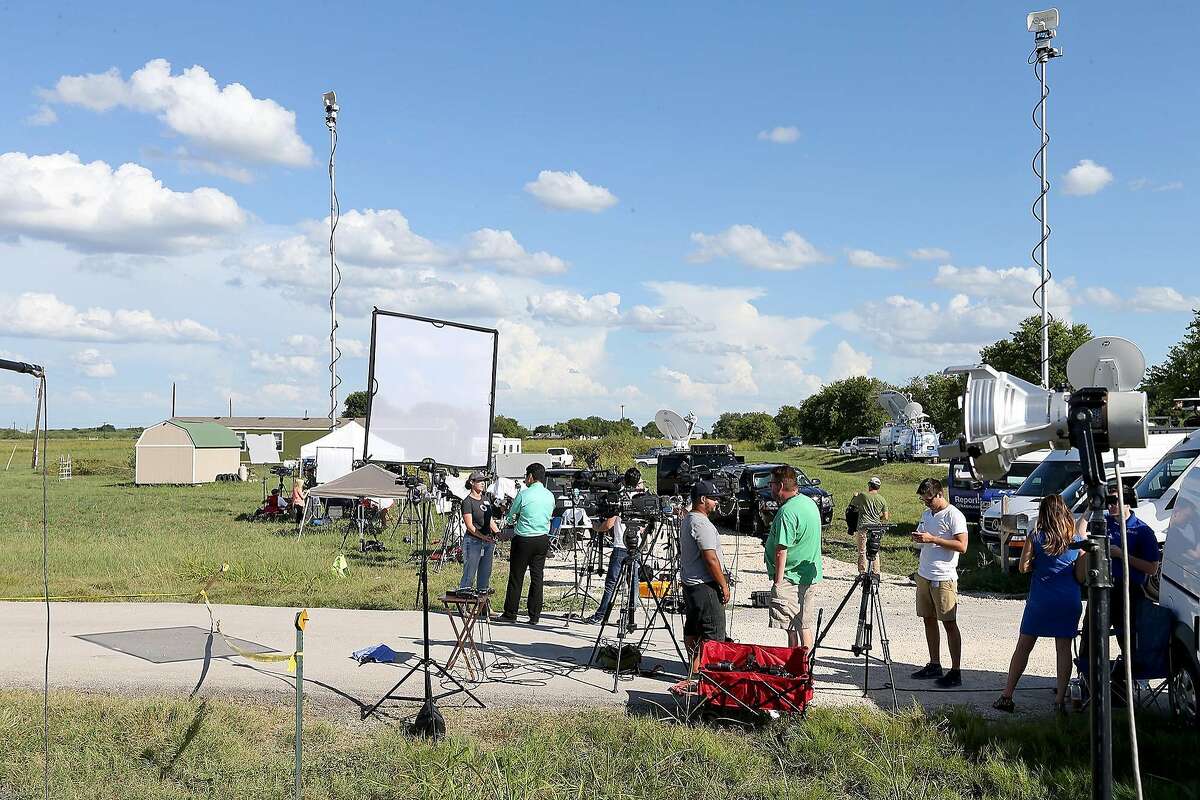 Members of the media gather near the scene of a hot air balloon crash that reports indicate took the lives of 16 people near Maxwell, Texas in Caldwell County on Saturday, July 30, 2016.