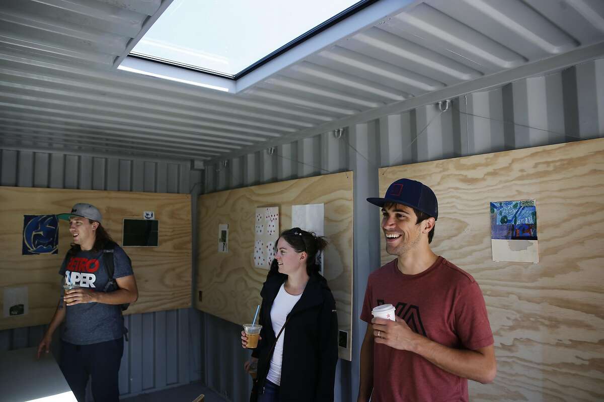 Nearby residents (l to r) Kory Mathewson, Lana Cuthbertson and David Belo check out a shipping container that has bee transformed into an art gallery at the Hayes Valley Artworks, an art activation site where the Fell St. offramp used to be near Octavia, in San Francisco, California, as seen on Sat. July 30, 2016.