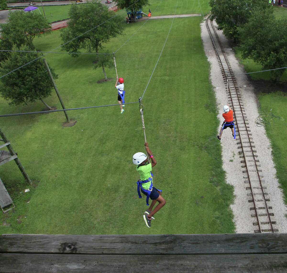 Champions Kids campers leave their fears on the platform as they ride the zipline. The camp has grown from a few dozen kids to almost 200. The founders also are exploring the possibility of a college scholarship.