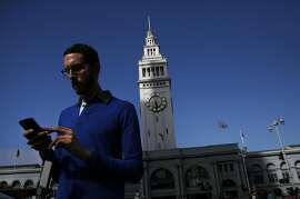 State Senate candidate Scott Wiener attempts to catch Pok�mon outside of the Ferry Building  during a Pok�mon Go "duel" between Jane Kim and Wiener July 30, 2016 in San Francisco, Calif.
