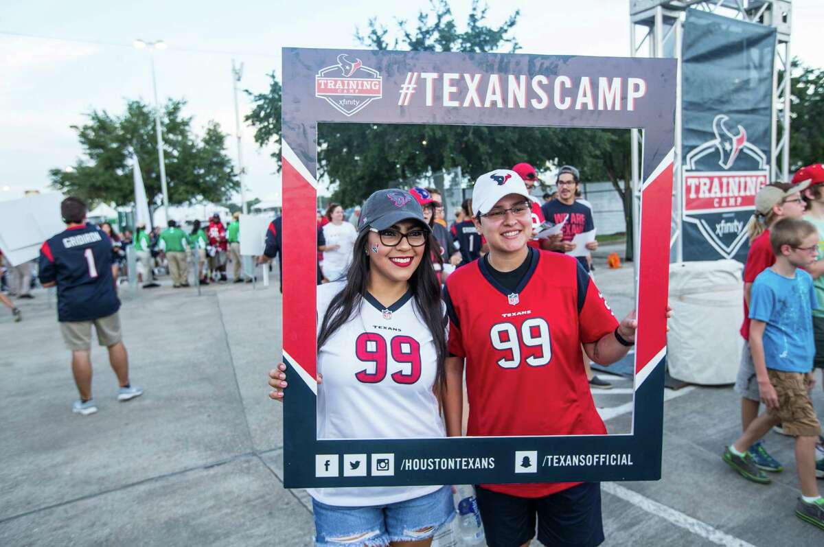 Houston Texans fans Brandy Martinez, left, and Janine Williams pose for a photo as they arrive for the first day of Texans training camp at Houston Methodist Training Center on Sunday, July 31, 2016, in Houston.