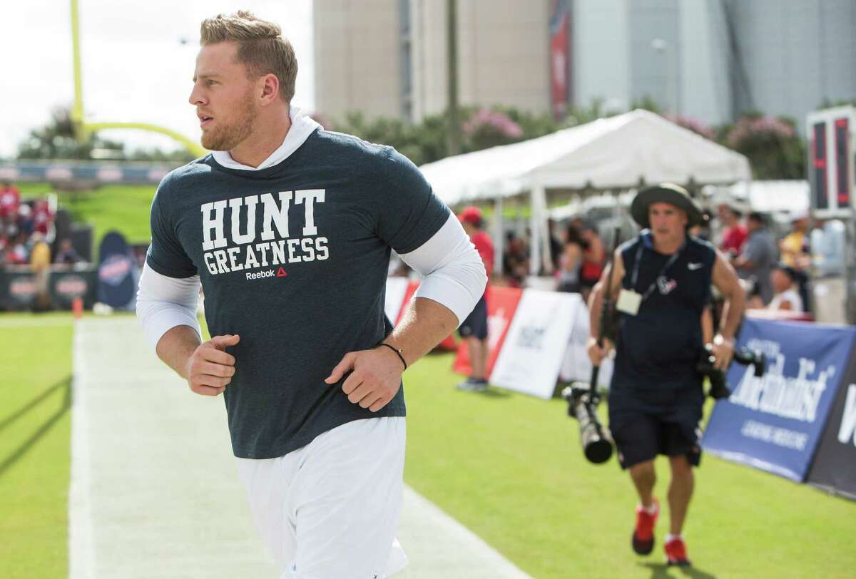Houston Texans defensive end J.J. Watt runs onto the practice field during Texans training camp at Houston Methodist Training Center on Sunday, July 31, 2016, in Houston. Watt is unable to practice as he is recovering from back surgery.