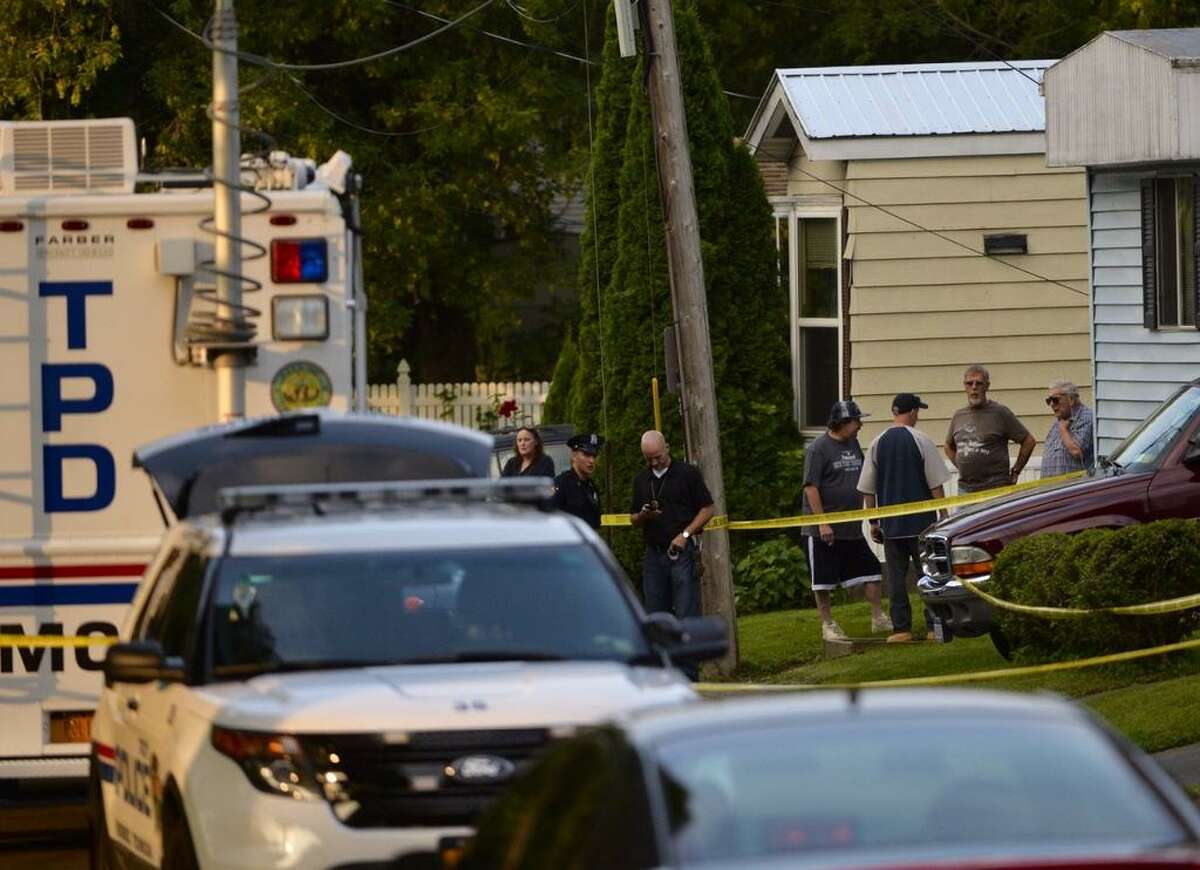 Troy police investigate the deaths of two people who were brutally beaten inside the trailer home at 709 First Ave. on Wednesday, Aug. 20, 2014, in Troy, N.Y. (Skip Dickstein / Times Union archive)