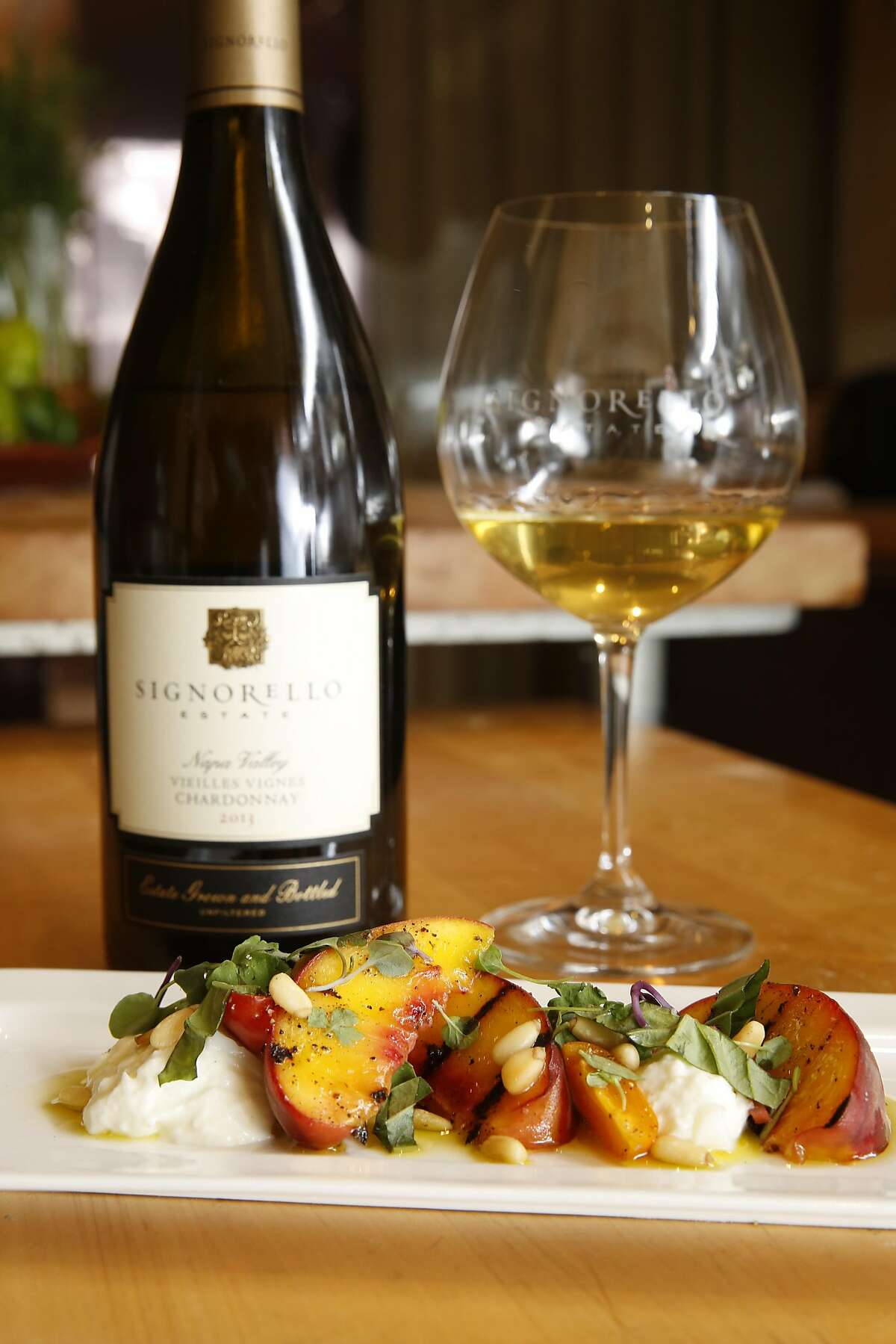 Wine pairing tasting premium experience at $175 at Signorello Estate winery in Napa, California on Saturday July 30, 2016. Grilled farmers market peaches, burrata, pickled radishes, basil and pine nuts prepared by chef Michael Pryor. Paired with 2013 Vieilles Vines Chardonnay, Estate.