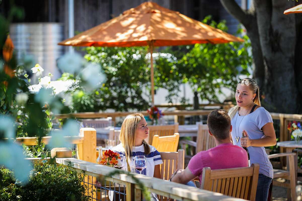 Alysha Strader (right) chats with Emily Webb and Tommy Buhr during a wine tasting at Saintsbury winery in Napa, California, on Monday, July 18, 2016.