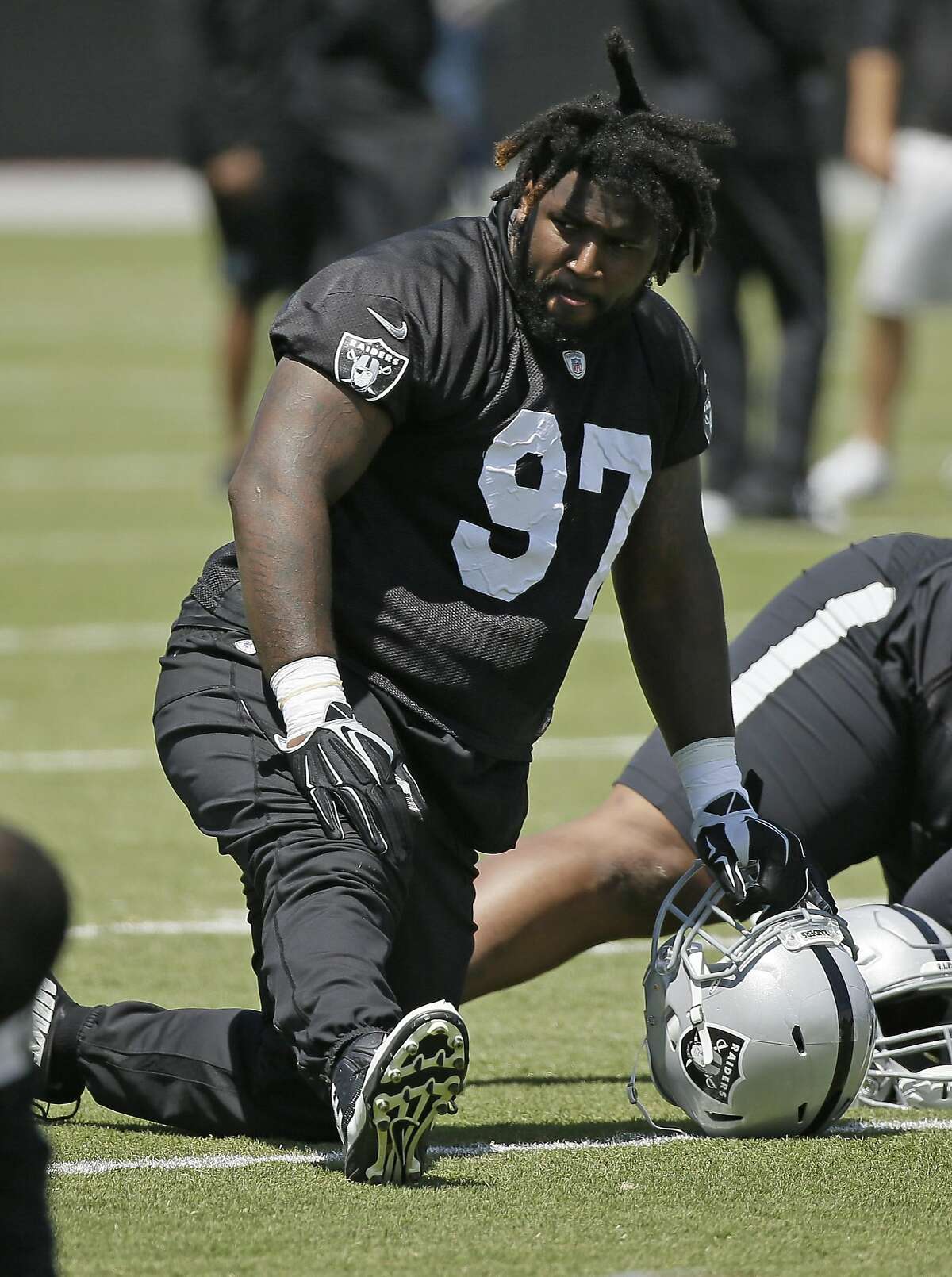 Oakland Raiders defensive end Mario Edwards stretches during their football minicamp Tuesday, June 14, 2016, in Alameda, Calif. (AP Photo/Eric Risberg)