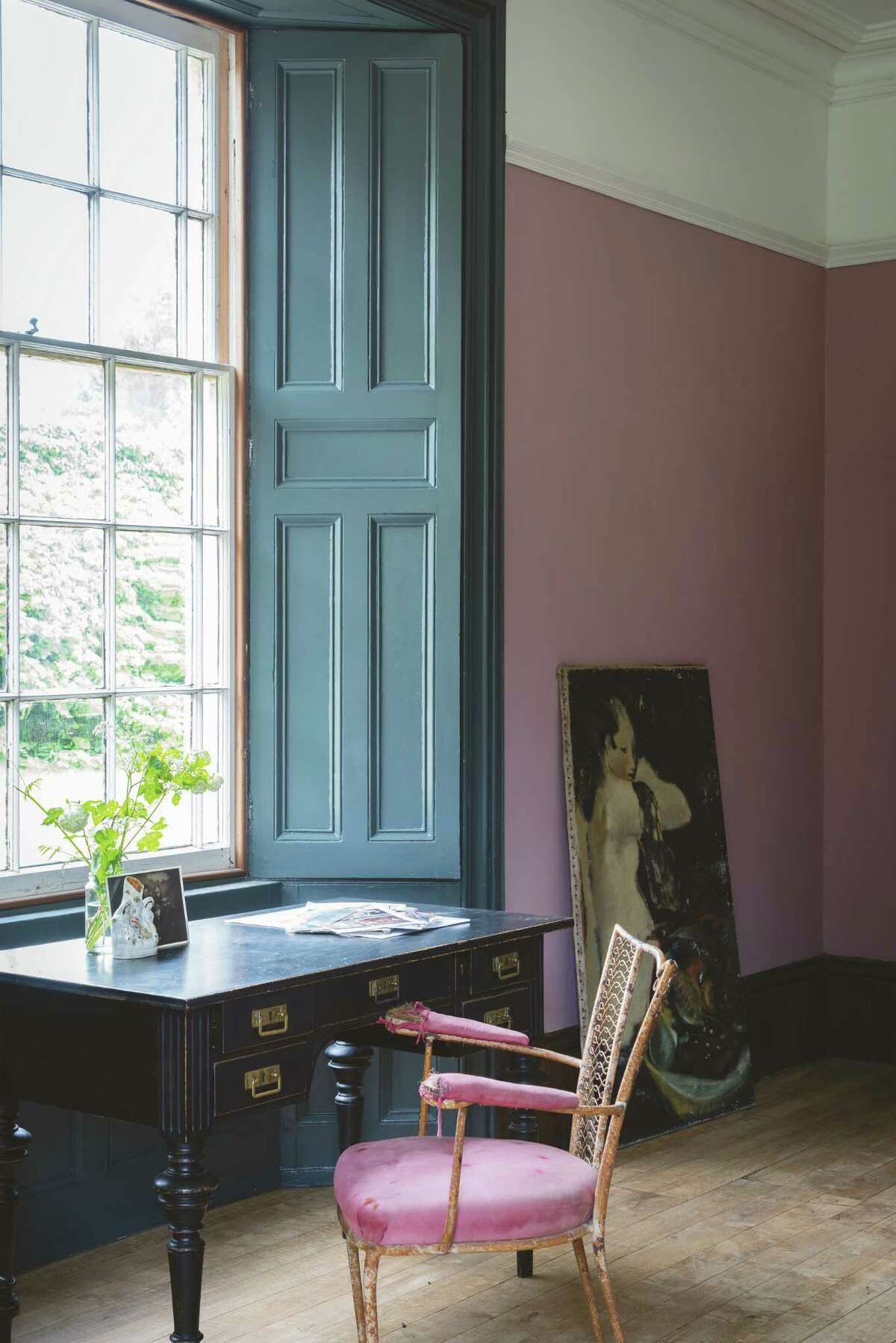 Glossy paint was used on the woodwork and flat paint was used on the walls. Full-gloss paint bounces light off of the shutters and feels traditional.