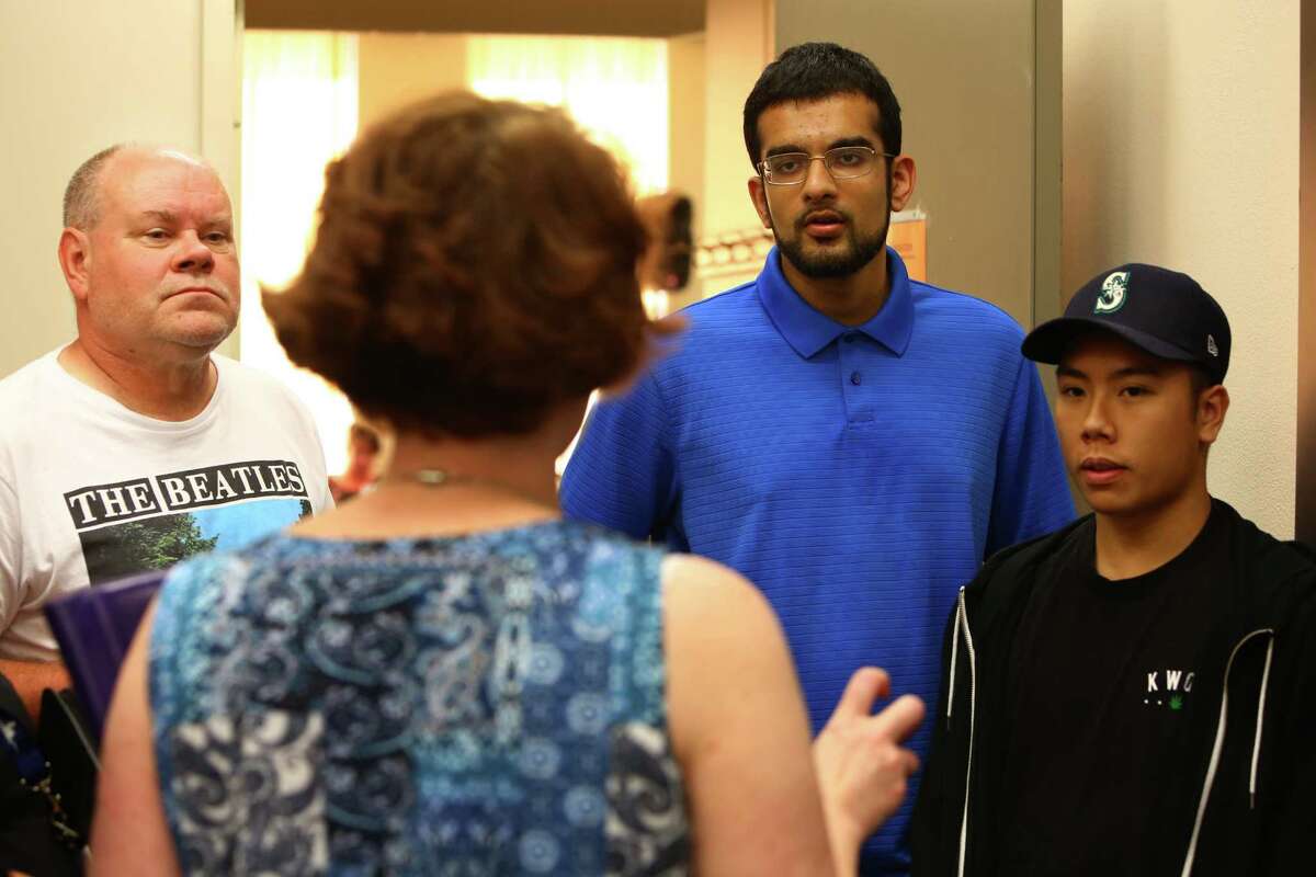 Court victims advocate Christina Harkness speaks with Mukilteo resident Terry Thomas, left, and former Kamiak students and friends of both the victims and suspect Sultan Akbar, center-right, and Andre Nguyen, right, after a bail hearing for Mukilteo shooting suspect Allen Ivanov the Snohomish County Courthouse, Monday, August 1, 2016. Ivanov was ordered by the judge to be held with out bail and to have no contact with the victims' families.