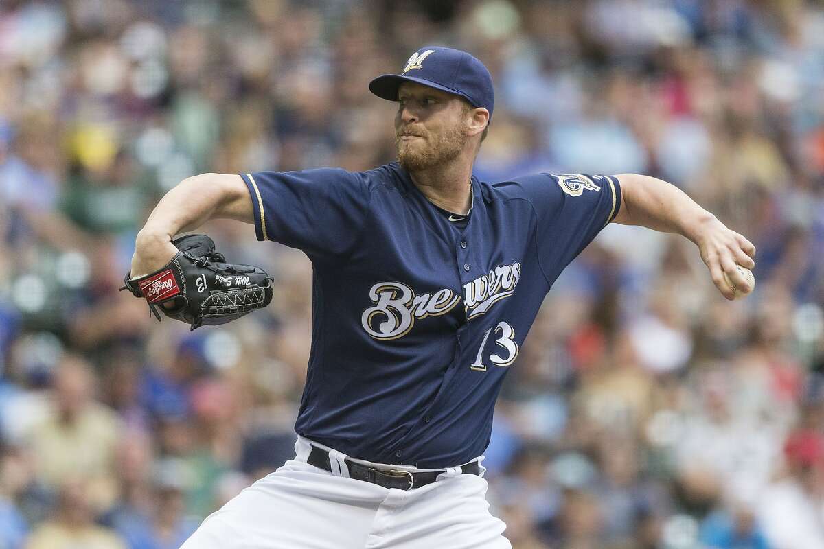 In this July 28, 2016, file photo, Milwaukee Brewers' Will Smith pitches to an Arizona Diamondbacks' batter during the seventh inning of a baseball game, in Milwaukee. The San Francisco Giants have acquired left-handed reliever Will Smith from the Brewers to bolster their bullpen for the stretch run.