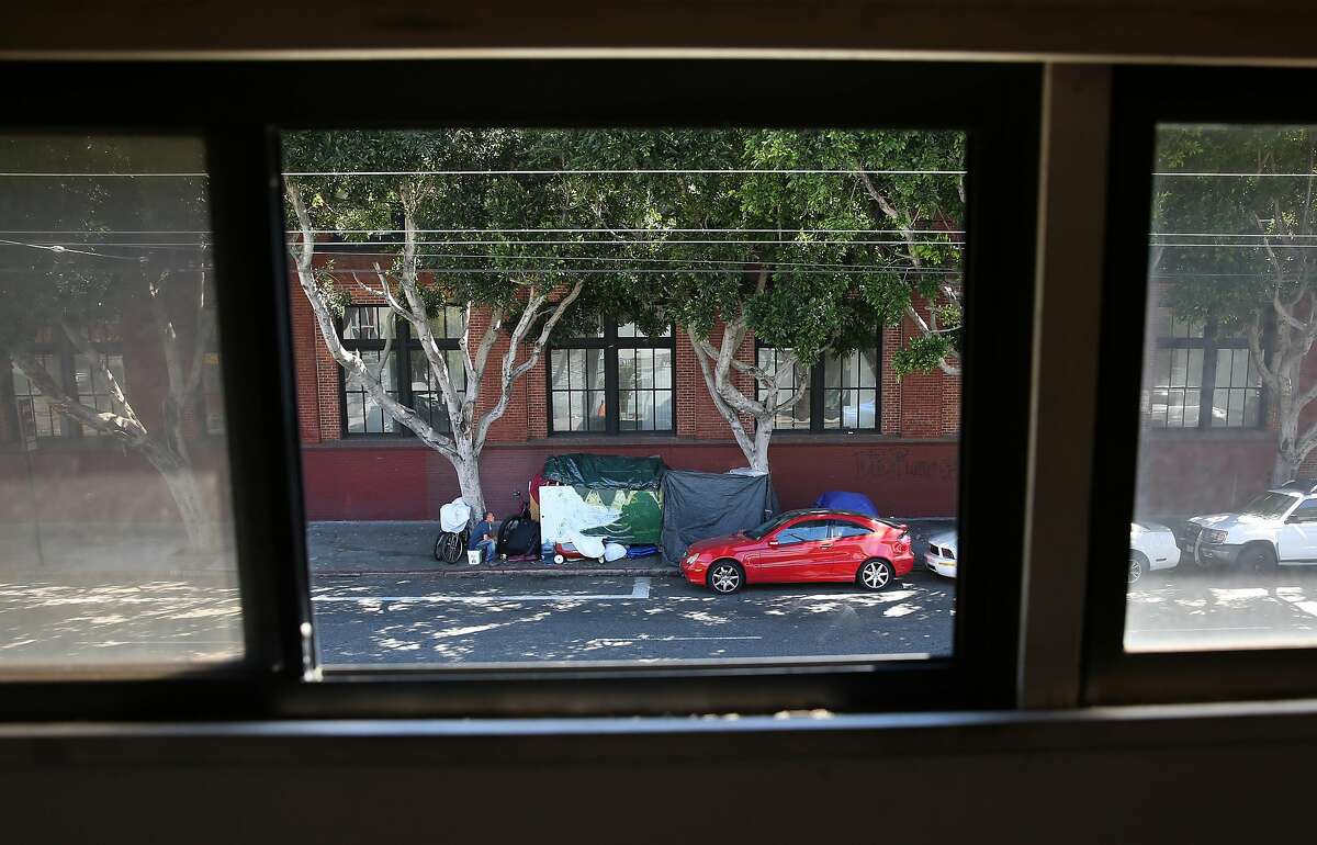 A homeless encampment seen through the windows of building owner Doug MacNeil of Spiral Binding, on Monday, August 1, 2016, in San Francisco, Calif.