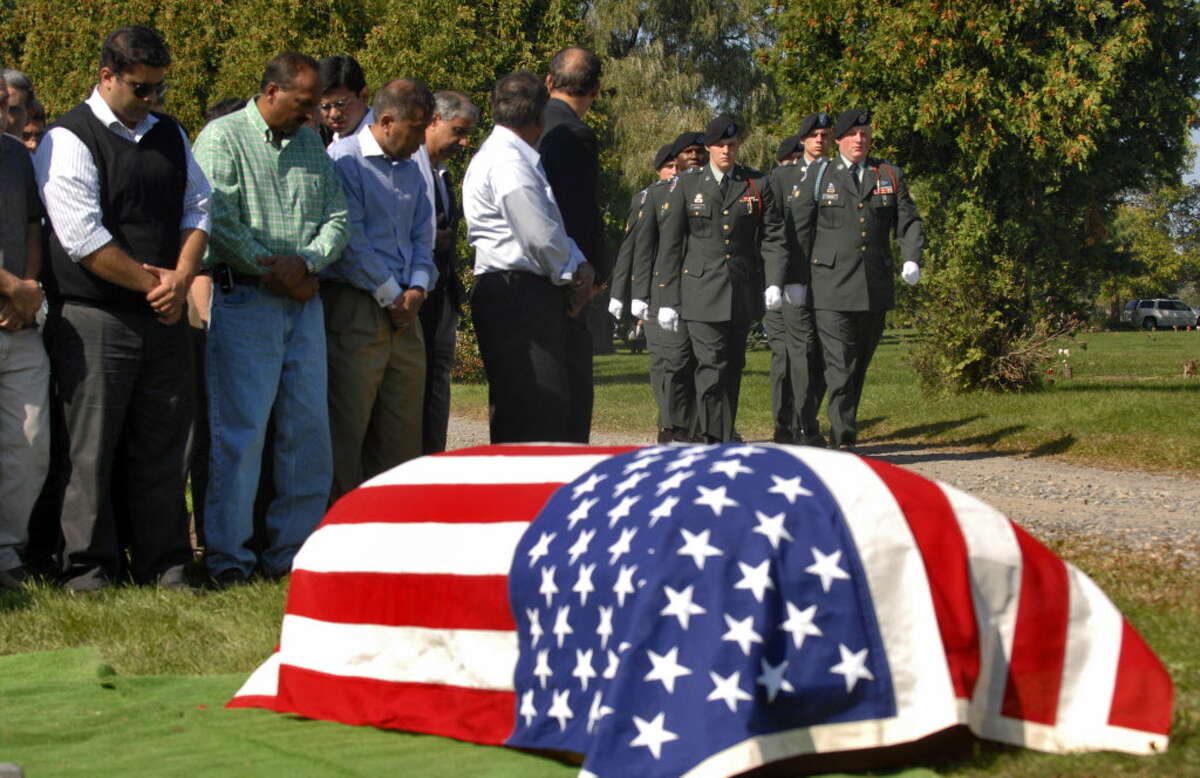 An honor guard from the 10th Mountain Division of Fort Drum approaches the casket of 1st Lt. Mohsin Naqvi, killed in Afghanistan by a roadside bomb on September 17, 2008, during his burial service on Monday, Sept. 22, 2008, in Colonie, N.Y. (Philip Kamrass/Times Union archive)