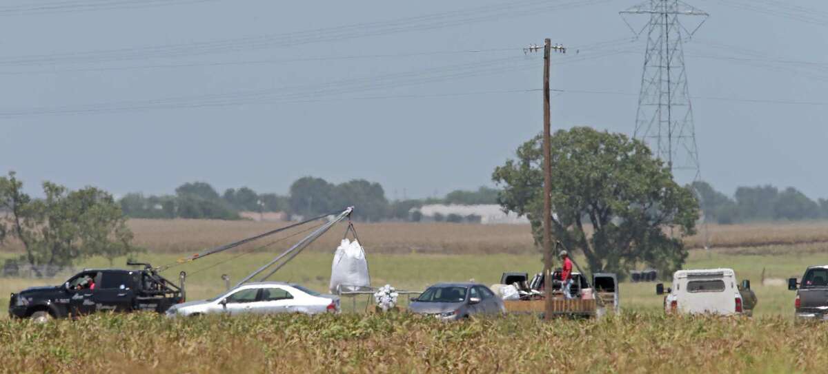 Workers remove debris, Monday Aug. 1, 2016, at the site of a hot air balloon crash that killed 16 people on Saturday July 30, 2016 near Maxwell, Texas in Caldwell County.