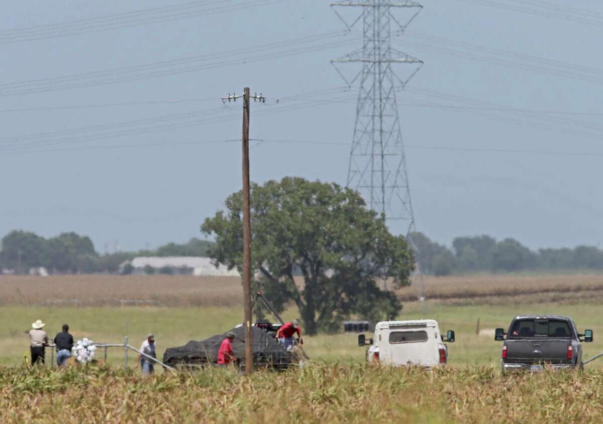 Workers remove debris, Monday Aug. 1, 2016, at the site of a hot air balloon crash that killed 16 people on Saturday July 30, 2016 near Maxwell, Texas in Caldwell County.